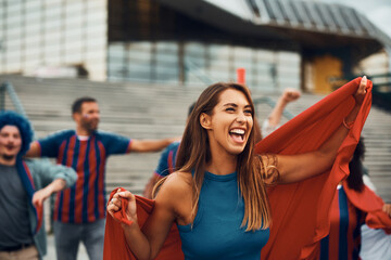 Cheerful woman celebrates with group of sports fans during soccer world championship.