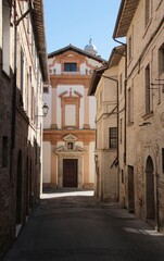 Italy, Umbria: Old street with Church in Bevagna.