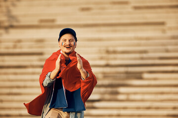 Young sports fan clapping hands while cheering and looking at camera. Copy space.