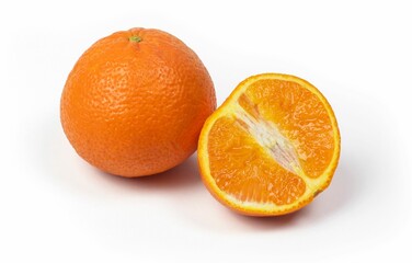 Closeup shot of a juicy whole orange and halved orange isolated on a white background