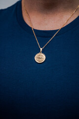 Fototapeta na wymiar man with necklace model posing pendant silver gold jewellery sweater