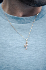 Fototapeta na wymiar man with necklace model posing pendant silver gold jewellery sweater