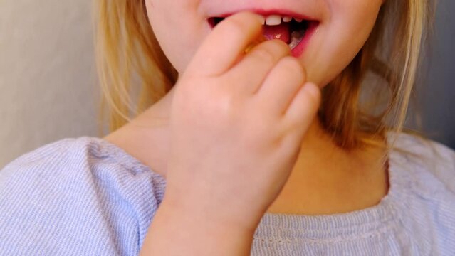 small child, blonde girl 3 years old wants to eat gelatinous sweets, gummy bear, kid has a good appetite, happy childhood, balanced diet, sweet life, unhealthy food, halal food