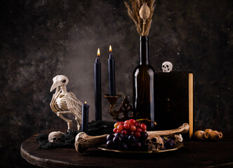 Halloween still life with skull, bones and cake