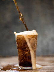 Brown soft drink splash on table.