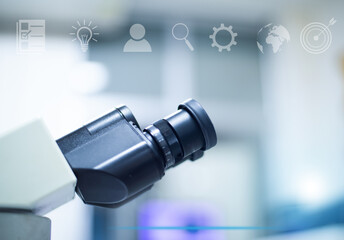Naklejka premium Microscope in laboratory with tecnology background.