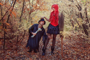 Fairy tale story, beautiful witch and dwarf in fairytale forest in autumn.