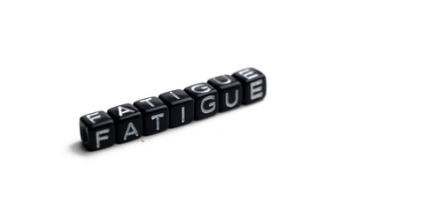 Fatigue, Closeup of word on plastic cube on wooden desk background concept