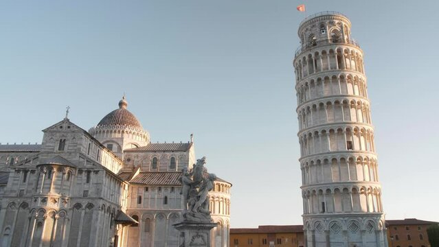 establish shot of cathedral, statue and leaning tower of pisa on the pisa square in the morning with slider or gimbal movement in tuscany italy