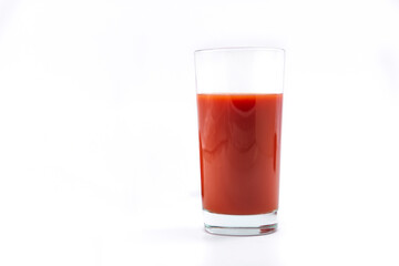 Glass with fresh tomato juice  and  tomatoes on a white background