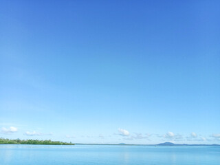 Beautiful seascape. The sea horizon, mountain and blue sky, natural photo background.