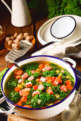 autumnal kale soup with sausage and bacon cubes