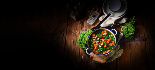 Obraz na płótnie Canvas autumnal kale soup with sausage and bacon cubes