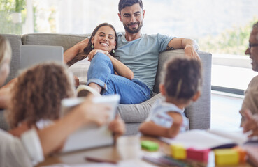 Family, children and parents love with a mother and father watching the kids while learning or playing in the living room. Happy, home and relax with a man and woman on a sofa in their home to relax