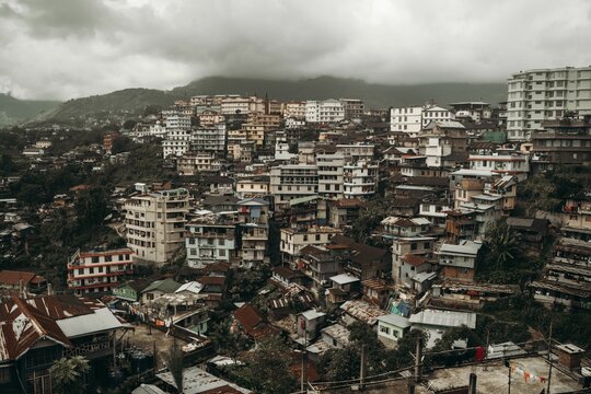 Drone shot of the beautiful cityscape of Kohima on a cloudy day in India