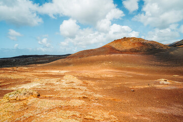 Arid volcanic landscape with lava fields in Timanfaya National Park, Lanzarote, Canary Island, Spain