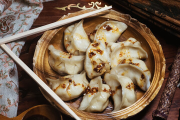 Freshly made Chinese Dumplings with pork with sour cabbage, vegetables with eggs, beef with celery