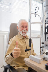 Elderly man showing thumbs up at the doctor