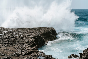 Water splash on black volcanic rocks of Tenesar, Lanzarote, Canary Islands