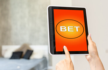 a woman makes bets on a tablet