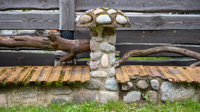 A Decorative Stone Fence Post For Delimiting A Private Area.