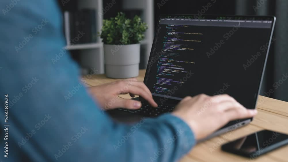 Aufkleber man in denim shirt coding software at laptop, desk with computer writing code, office workplace