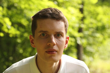 Young man face on a green nature background. Pavel Kubarkov, my face on a green background. Photo was taken 13 July 2022 year, MSK time in Russia. - 534187875