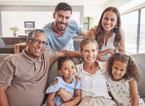 Happy big family, smile and sofa portrait in home living room, bonding and caring. Love, diversity and grandparents, parents and girls spending good quality time together in relax, support and care.