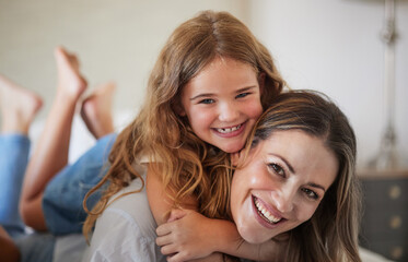 Relax, hug and portrait of mother with child in New Zealand family home enjoy bonding together. Care, love and happy mother smiling with young daughter in house on weekend for leisure time.