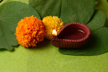 Indian Festival Dussehra, showing golden leaf and flowers on moody background. Greeting card.