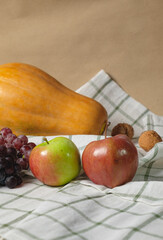 Autumn fruits, nuts and pumpkin.Thanksgiving background. Autumn concept with copy space.Vertical shot