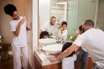 Kids and dad brushing teeth in bathroom, reflection in mirror and mom with phone taking picture at bedtime. Love, happy family and man and children with toothbrush and woman with smartphone in home.