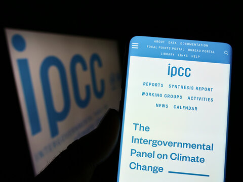 Stuttgart, Germany - 09-25-2022: Person holding cellphone with website of Intergovernmental Panel on Climate Change (IPCC) on screen with logo. Focus on center of phone display.