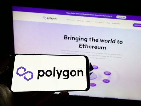 Stuttgart, Germany - 09-25-2022: Person holding mobile phone with logo of Indian Web3 company Polygon Technology on screen in front of business web page. Focus on phone display.