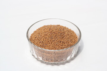 Mustard seeds on a glass bowl, mustard seeds on white background