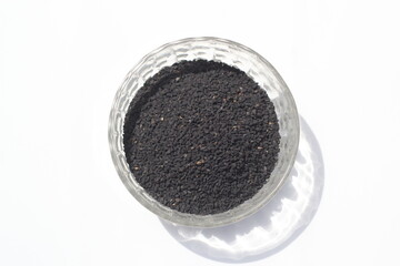 Black cumin seeds on a white background, black cumin seeds on a bowl