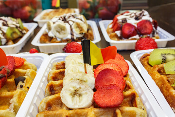 Showcase of traditional Belgian waffles decorated with flag of Belgium