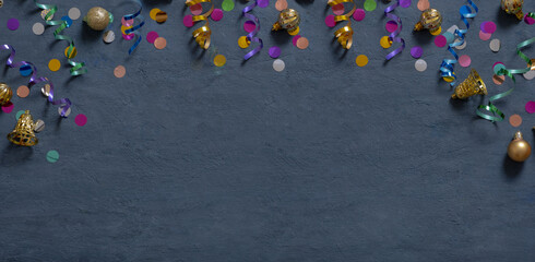 Banner with colorful tinsel and Christmas decorations on a dark cement background with copy space