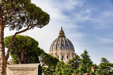 Dome of Saint Peter's Basilica against the cloudy blue sky. Vatican City, Italy.