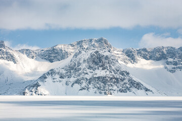 Fototapeta premium Heaven Lake, Tianchi in Chinese, winter landscape, caldera of Mount Paektu (Baekdu), volcano on Sino-Korean border, Changbai Mountains, Yanbian Korean Autonomous Prefecture (Yeonbyeon), Jilin, China
