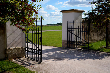 gate and fence at the castle in the autumn sun. the lattice ending the end of wall protected...