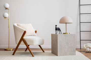 Interior design of harmonized living room with white boucle armchair, marble cube, gold lamp,...