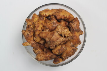 Ginger on a white background, fresh ginger on a bowl