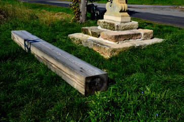 Repairing God's tortures in the countryside. the metal cross is painted and gilded. the...
