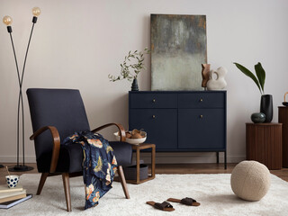 Creative composition of living room interior with mock up poster frame, velvet blue armchair,...