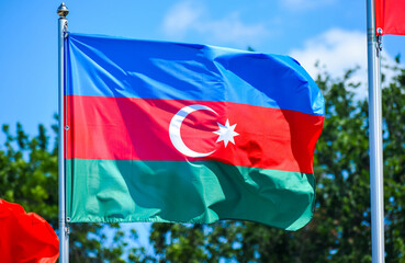 The flag of Azerbaijan consists of three equal horizontal stripes - blue, red and green, in the center of the flag in white depicts a crescent moon with an eight-pointed star