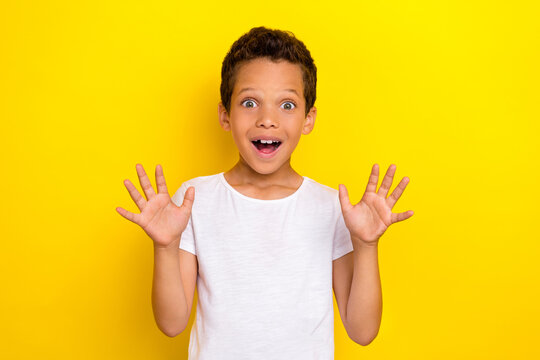 Photo Of Cute Astonished Boy Open Mouth Trendy White Outfit Raise Show Two Arm Enjoy Satisfied Sale Isolated On Yellow Color Background