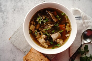 Homemade Lamb Goat or Mutton soup stew served in a bowl, selective focus