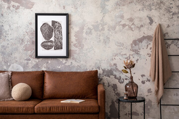 Obraz na płótnie Canvas Creative composition of living room interior with mock up poster frame, brown sofa, pouf, lamp and personal accessories. Gray concrete wall. Stylish home decor. Template. 