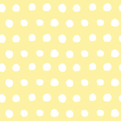 Abstract seamless background with hand drawn polka dots, gentle childish yellow and white pattern, minimalist design
